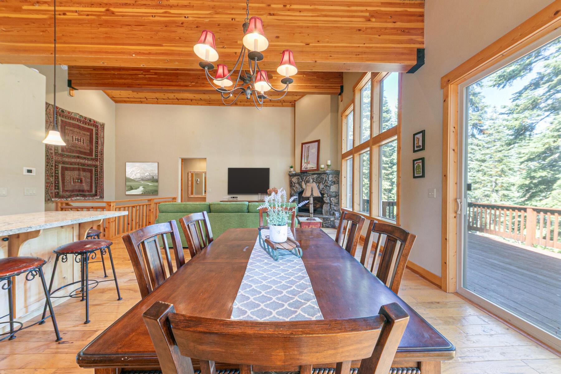11707 Ski Slope Way Truckee, CA 96161 - Photo 14 of 28 a view of a dining room with furniture a chandelier and wooden floor