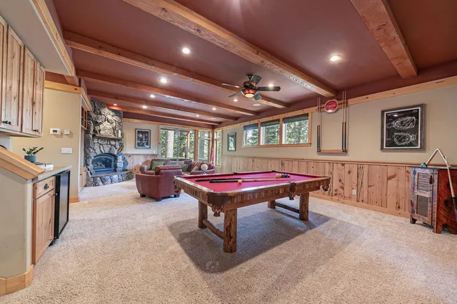 a room with furniture pool table and windows