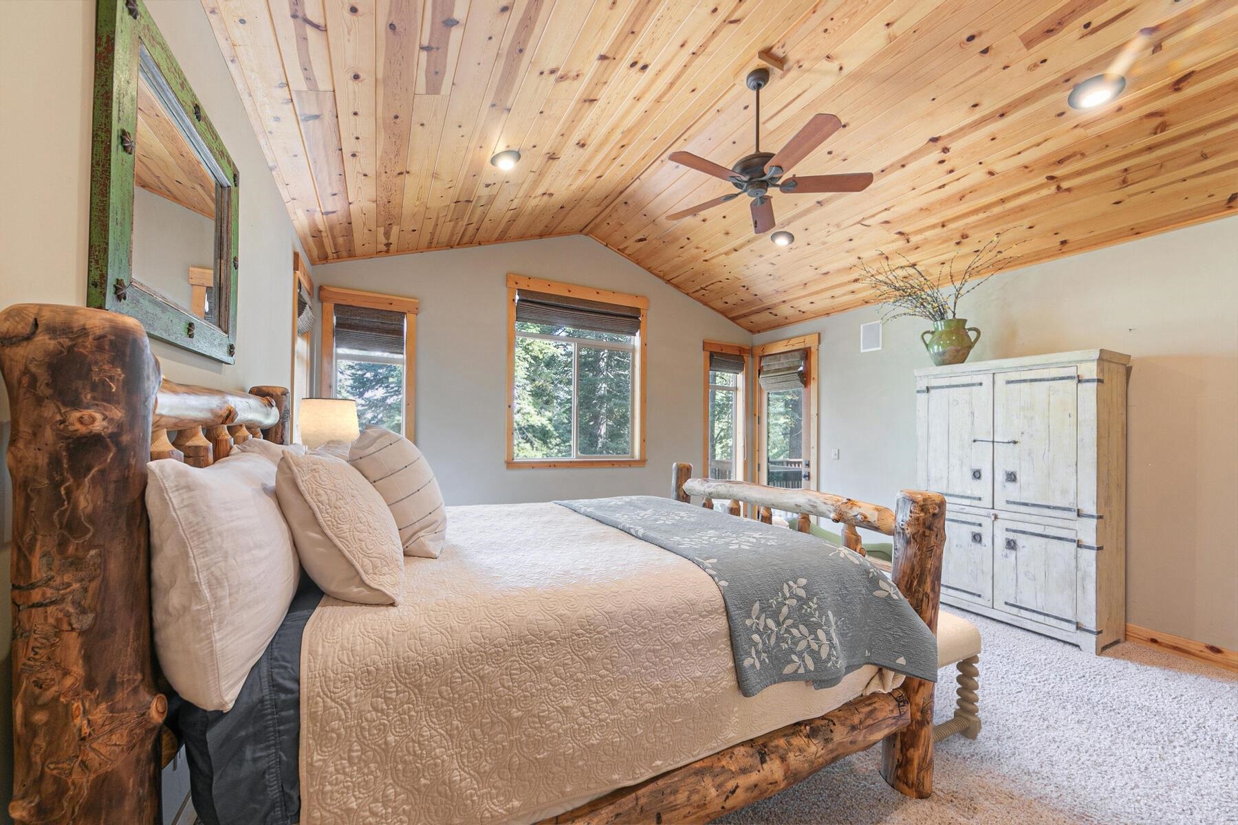11707 Ski Slope Way Truckee, CA 96161 - Photo 16 of 28 a bed room with a bed and a chandelier
