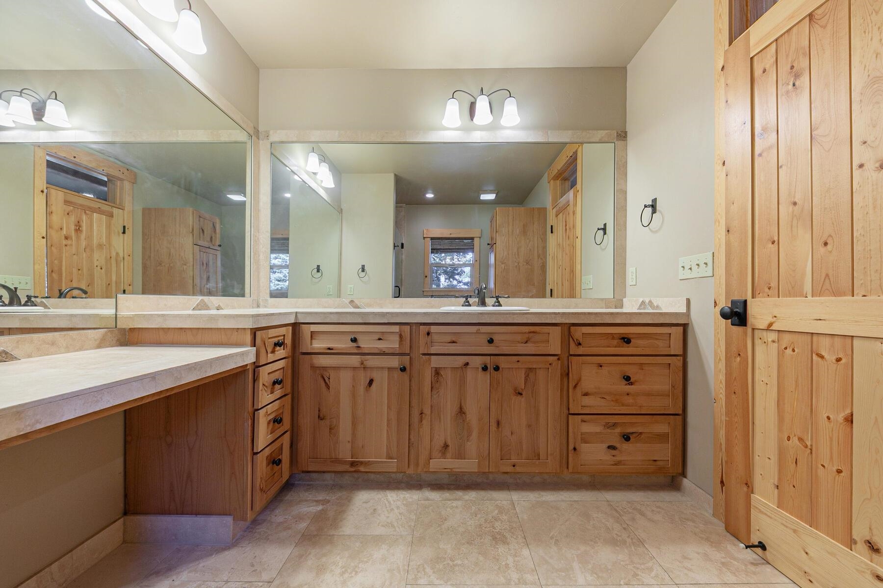 11707 Ski Slope Way Truckee, CA 96161 - Photo 21 of 28 a spacious bathroom with a granite countertop sink and a mirror