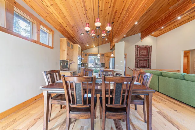 a view of a dining room with furniture and chandelier