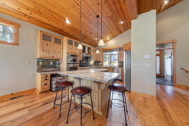 a kitchen with stainless steel appliances granite countertop a stove and a refrigerator
