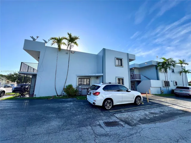 a car parked in front of white house
