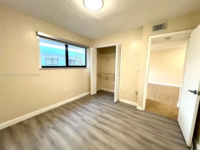 a bathroom with a toilet a sink a tub and mirror