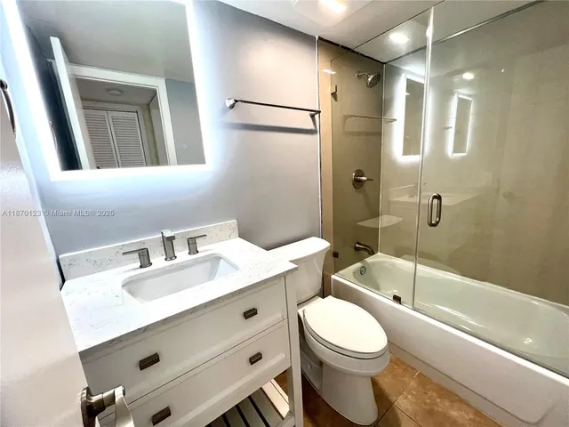 a kitchen with granite countertop a refrigerator and a stove top oven