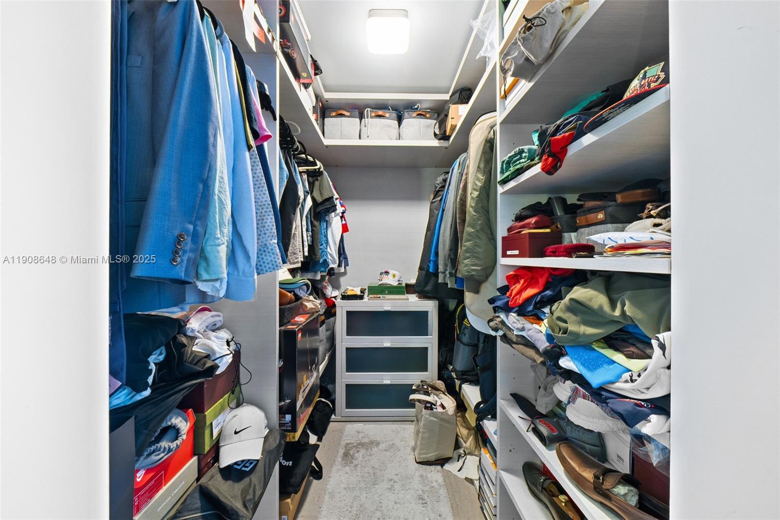 68 Southeast 6th Street, Unit 2505 Miami, FL 33131 - Photo 11 of 18 a view of walk in closet with clothes