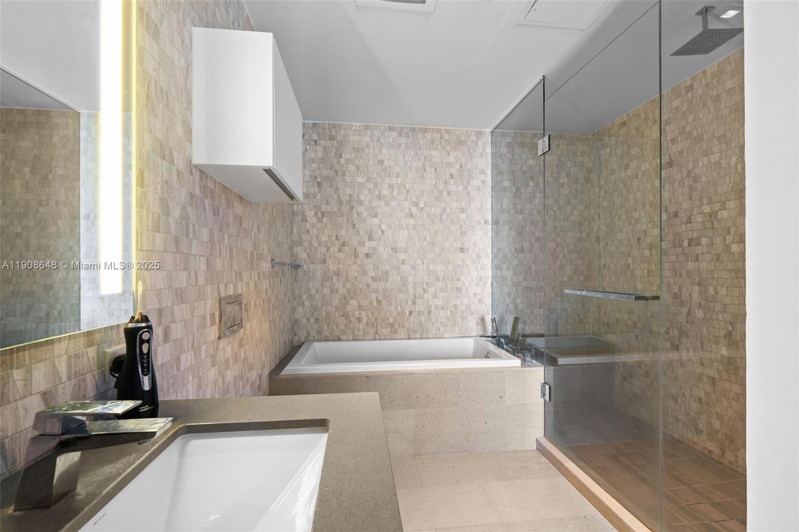 68 Southeast 6th Street, Unit 2505 Miami, FL 33131 - Photo 13 of 18 a bathroom with a tub and a shower