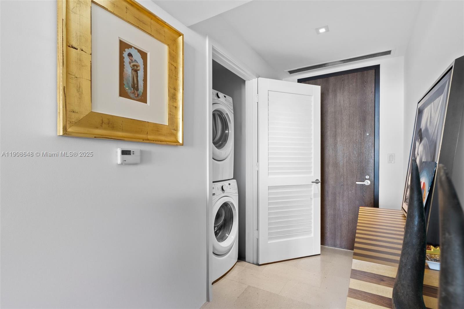 68 Southeast 6th Street, Unit 2505 Miami, FL 33131 - Photo 17 of 18 a bathroom with a sink and a mirror