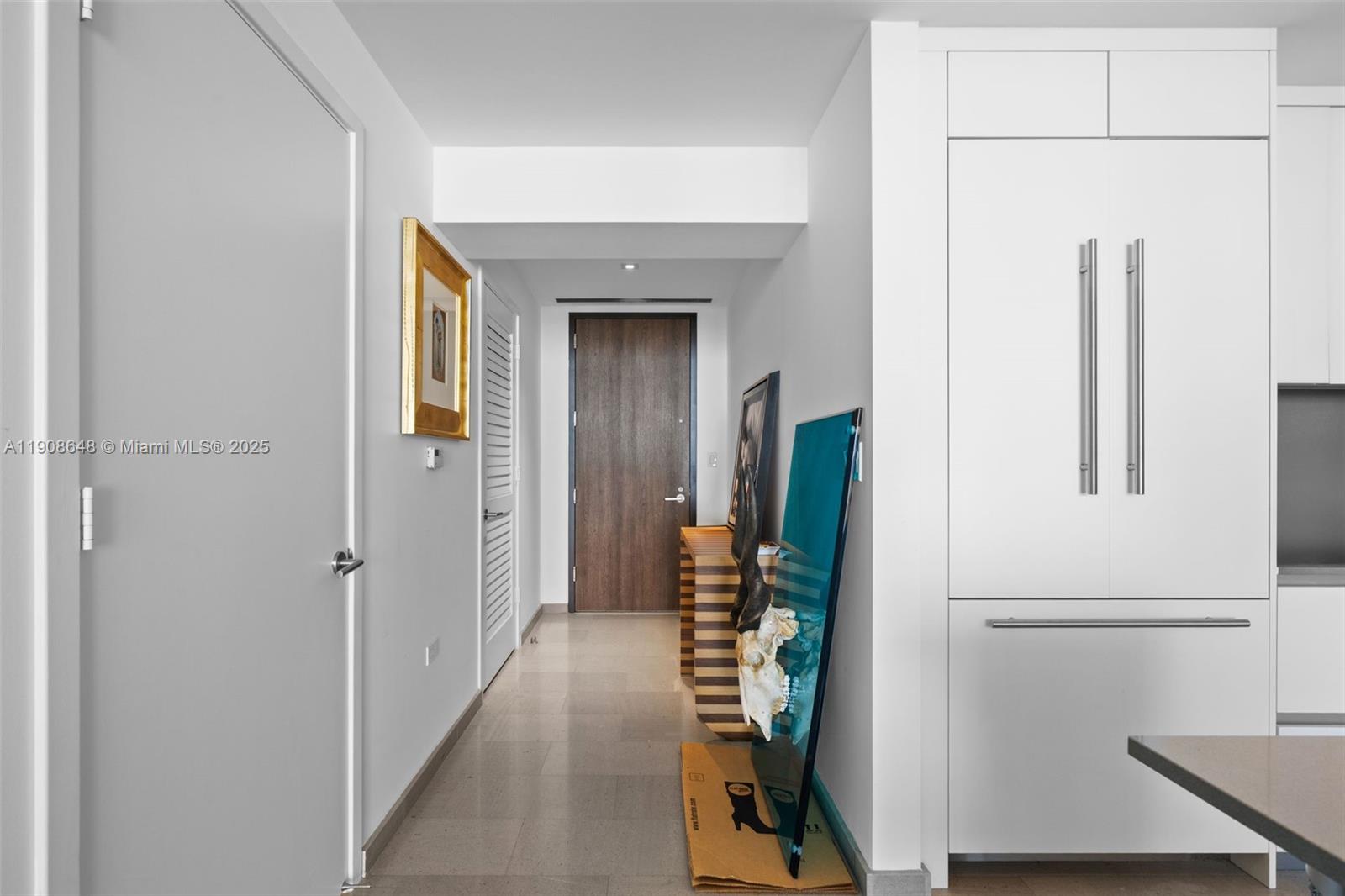 68 Southeast 6th Street, Unit 2505 Miami, FL 33131 - Photo 2 of 18 a view of a hallway with wooden floor and cabinets