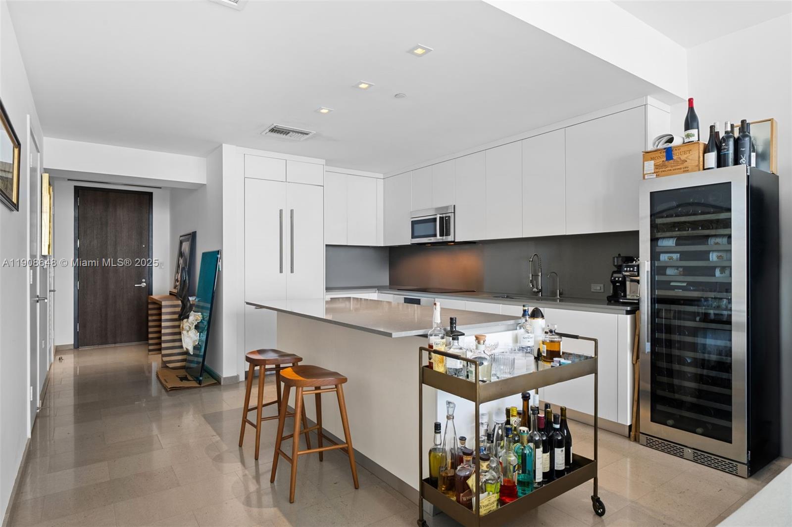 68 Southeast 6th Street, Unit 2505 Miami, FL 33131 - Photo 3 of 18 a kitchen with stainless steel appliances kitchen island granite countertop a refrigerator and a stove top oven