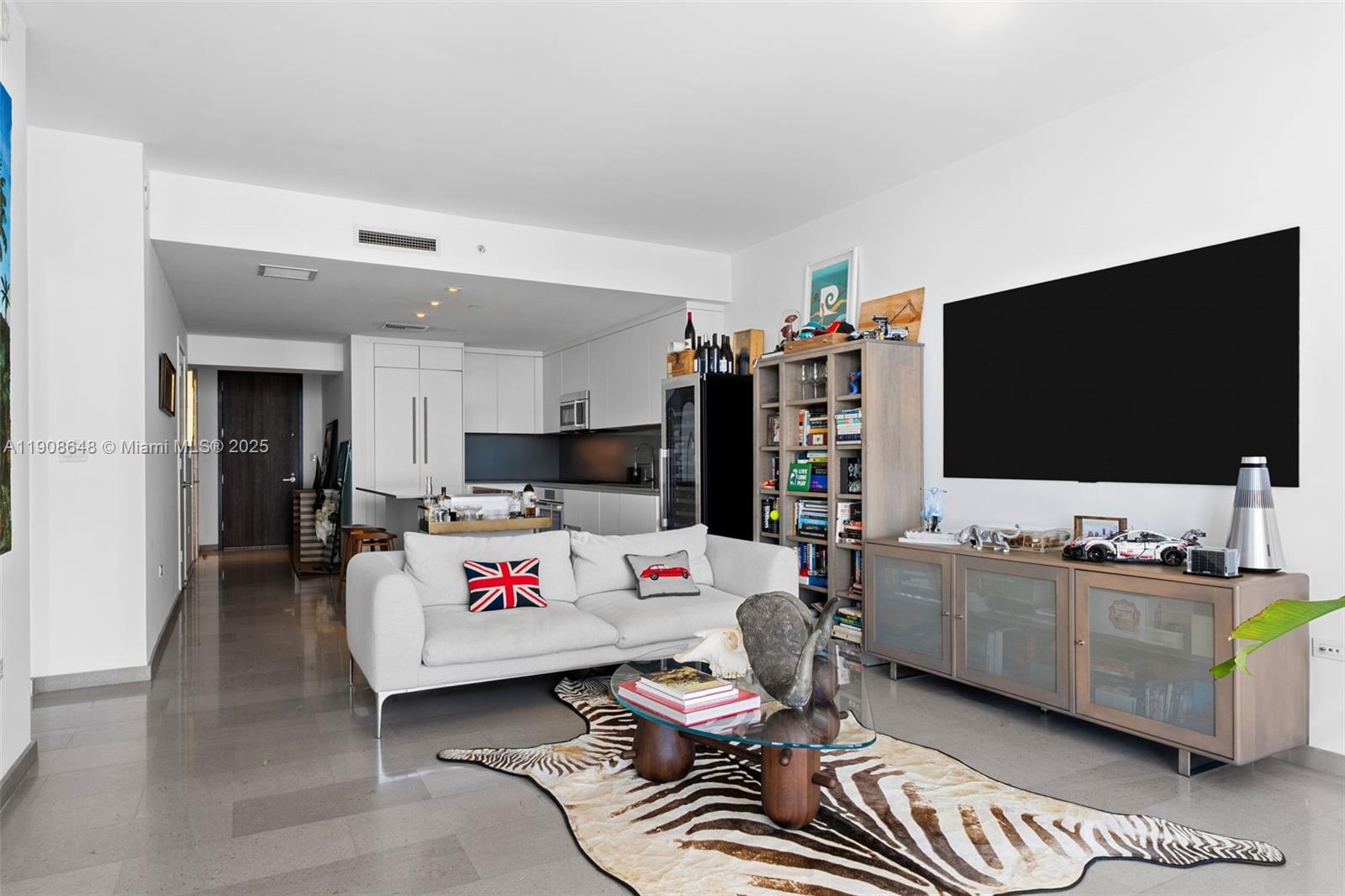 68 Southeast 6th Street, Unit 2505 Miami, FL 33131 - Photo 5 of 18 a living room with furniture and a flat screen tv