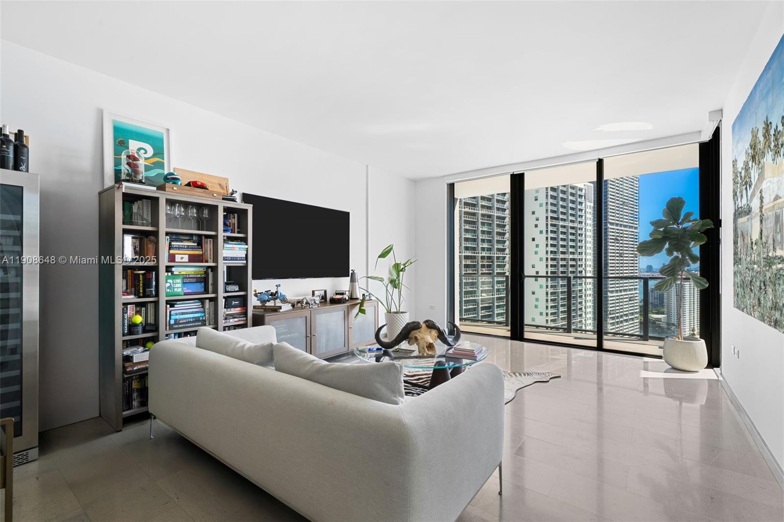 68 Southeast 6th Street, Unit 2505 Miami, FL 33131 - Photo 7 of 18 a living room with furniture a flat screen tv and a large window