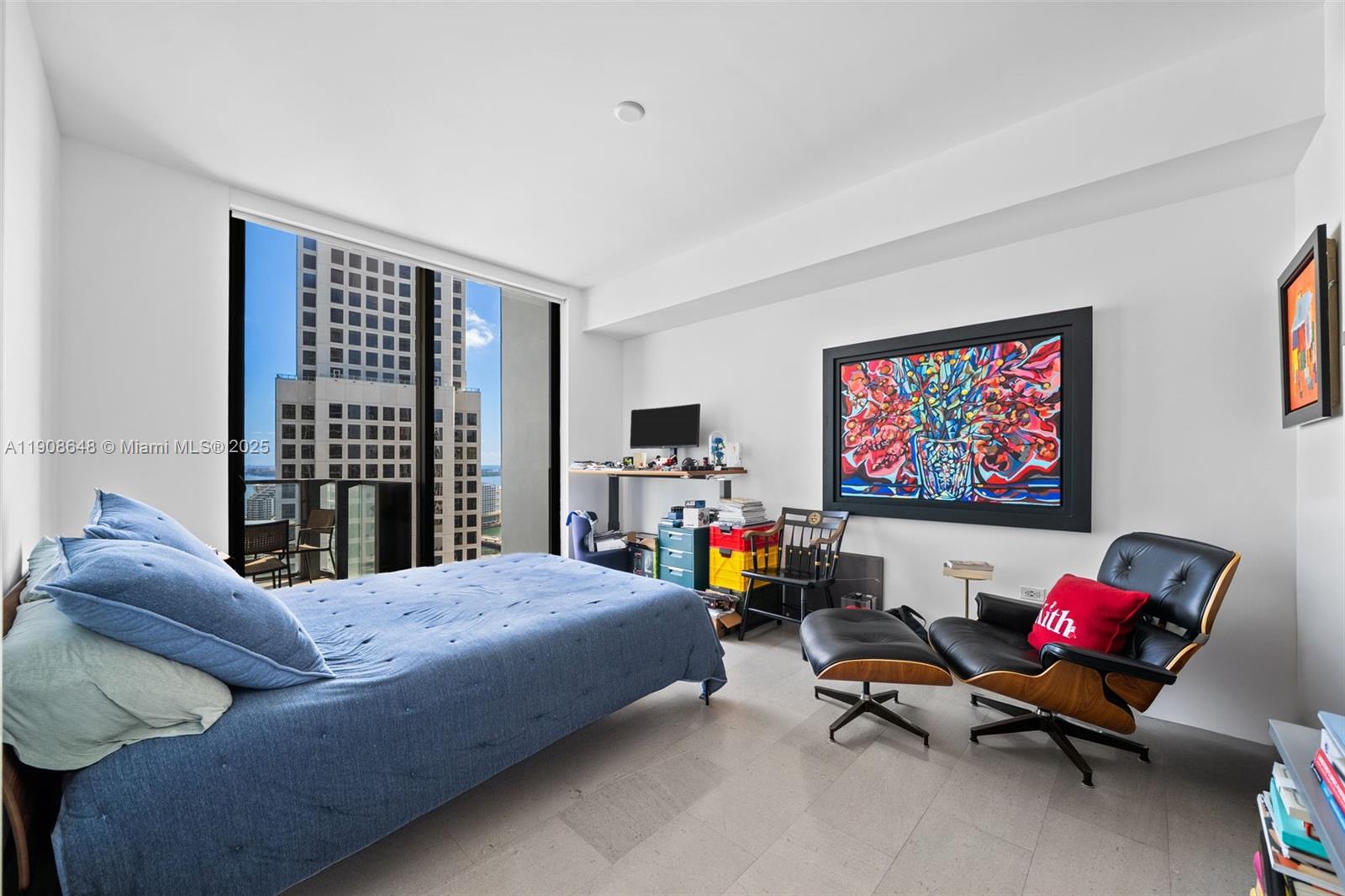 68 Southeast 6th Street, Unit 2505 Miami, FL 33131 - Photo 10 of 18 a bedroom with furniture and a flat screen tv