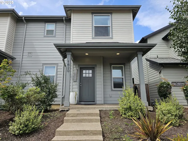 a view of a house with potted plants