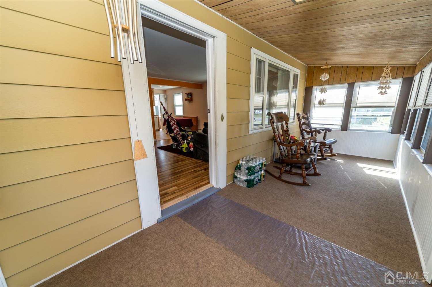 142 Weiss Terrace Raritan, NJ 08869 - Photo 5 of 29 a view of a hallway with chair and front door
