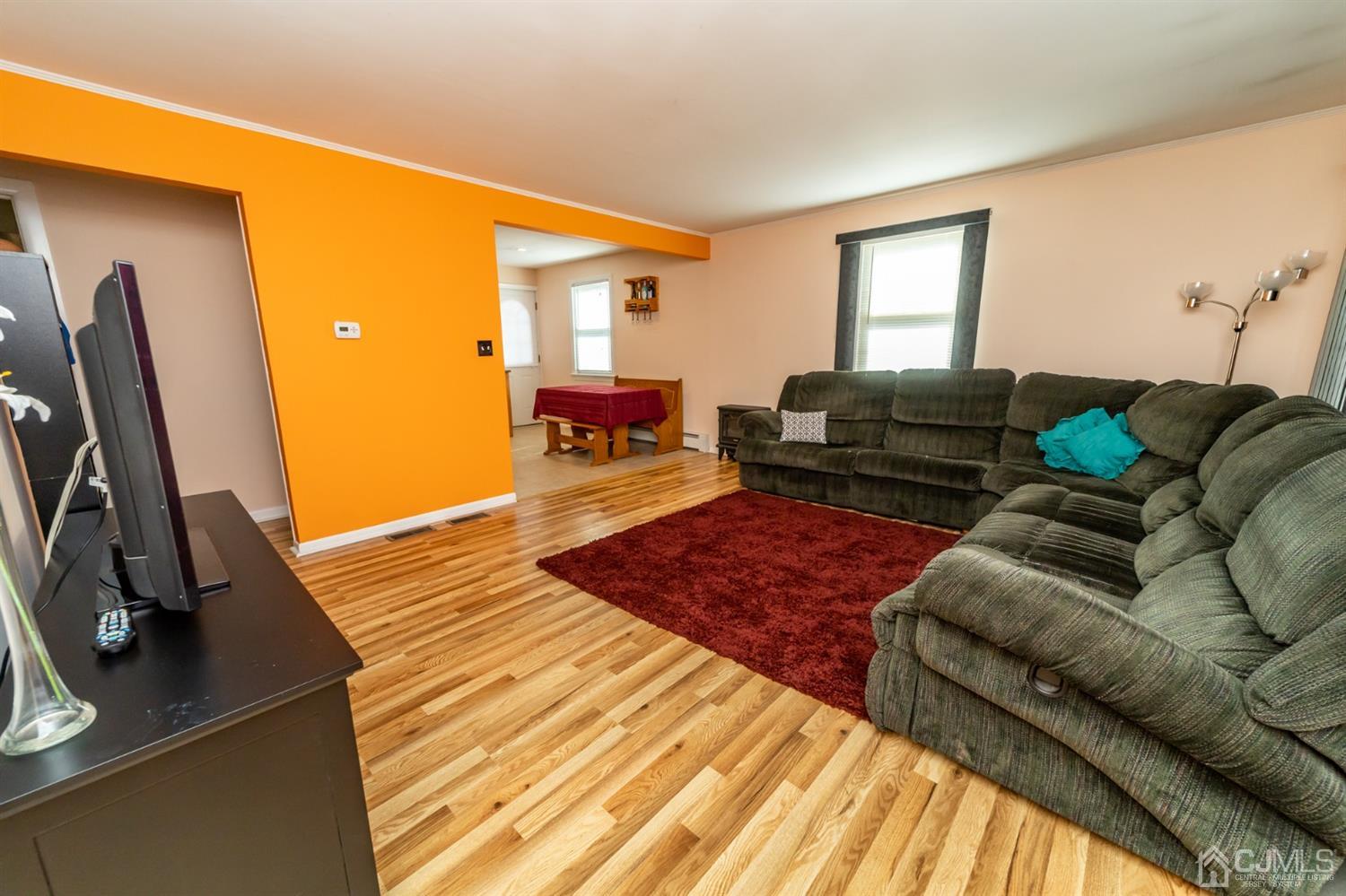142 Weiss Terrace Raritan, NJ 08869 - Photo 6 of 29 a living room with furniture and a flat screen tv