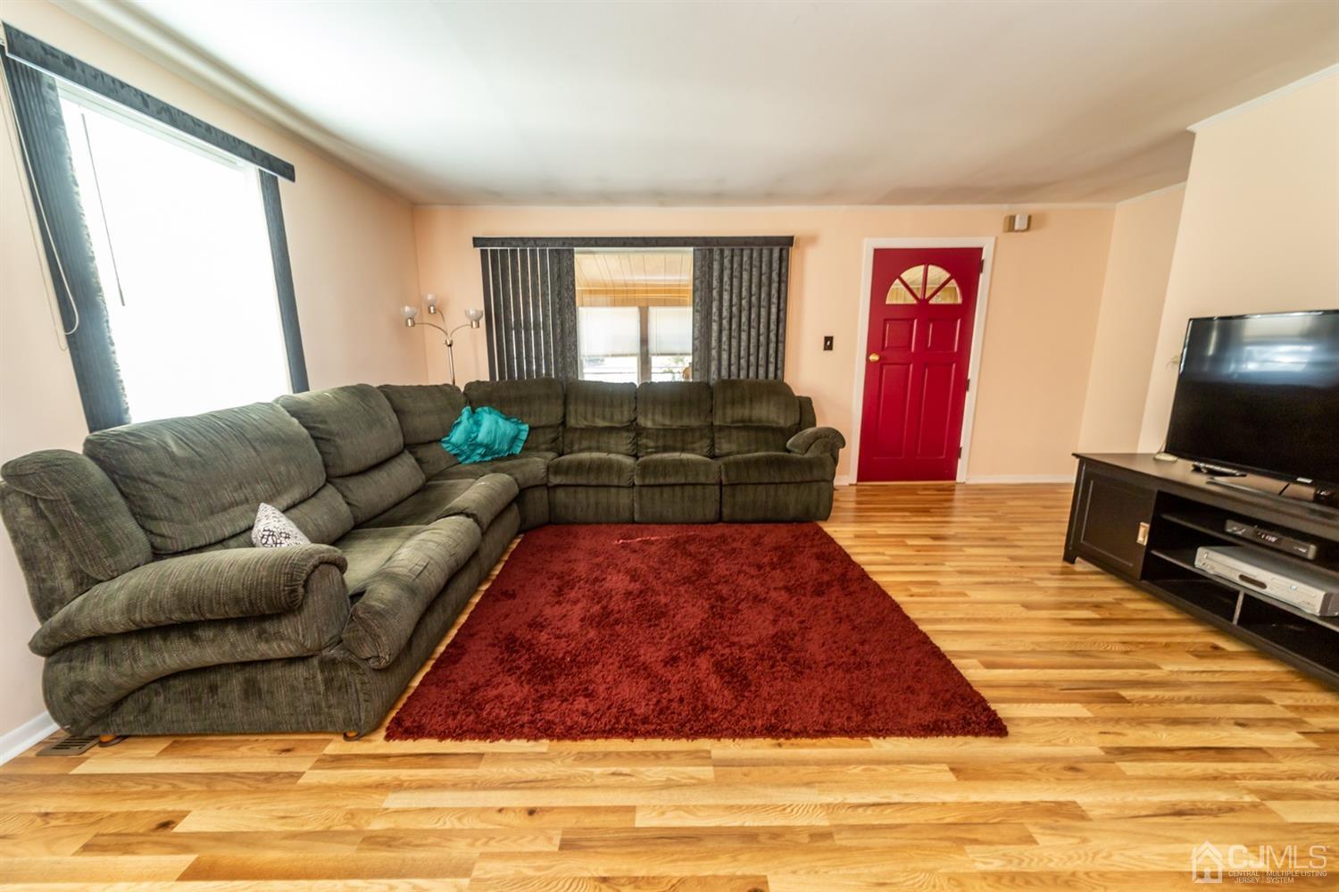 142 Weiss Terrace Raritan, NJ 08869 - Photo 8 of 29 a living room with furniture and a flat screen tv