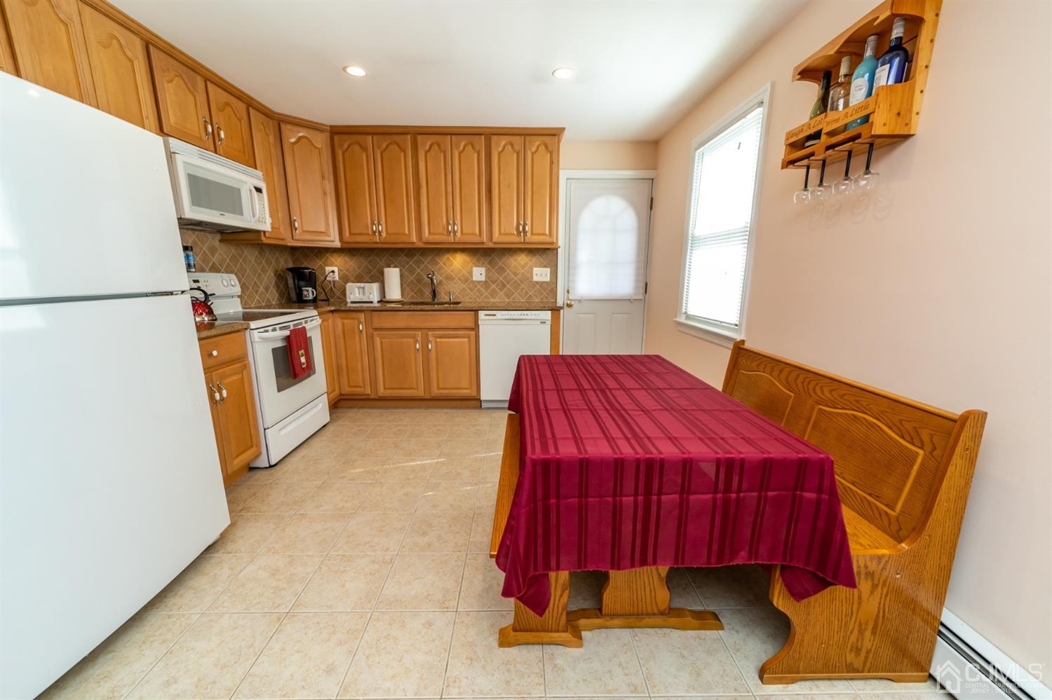 142 Weiss Terrace Raritan, NJ 08869 - Photo 10 of 29 a kitchen with stainless steel appliances a refrigerator sink and cabinets