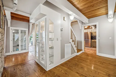 a living room with furniture and a floor to ceiling window