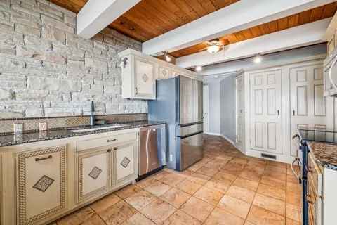 a bedroom with a bed a dresser and a window