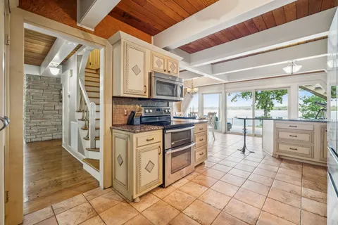 a bathroom with a granite countertop sink toilet and mirror