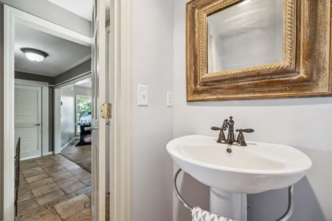 a view of a patio with table and chairs with wooden floor and fence