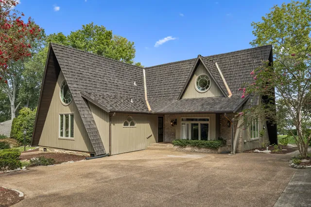 a living room with furniture a fireplace and a large window