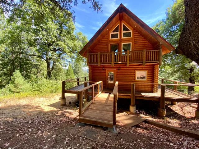a view of a wooden house with a yard