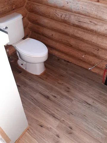 a view of balcony with wooden floor and fence