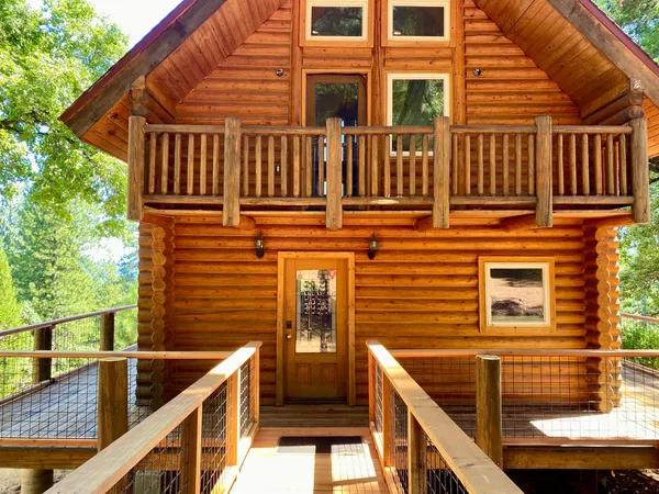 a view of balcony with wooden floor and fence