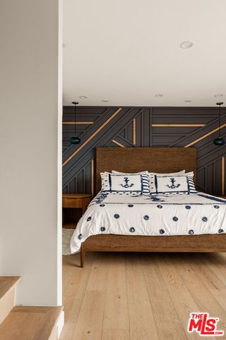 a large white bed sitting in a room