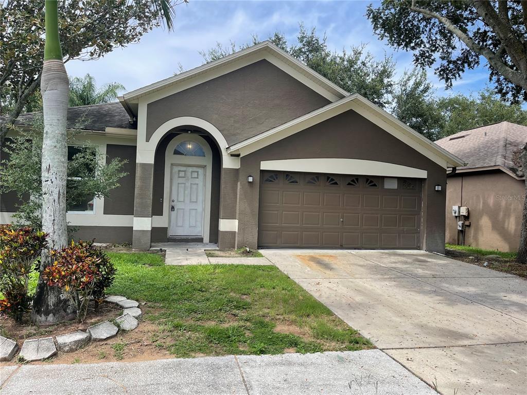 a front view of a house with a garden and plants