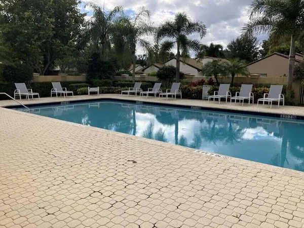 a view of a swimming pool with outdoor seating
