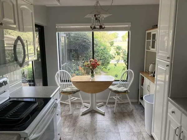 a view of a dining room with furniture window and outside view