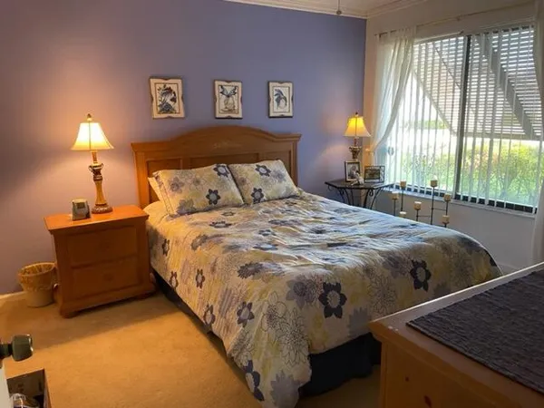 a bed sitting in a bedroom next to a window