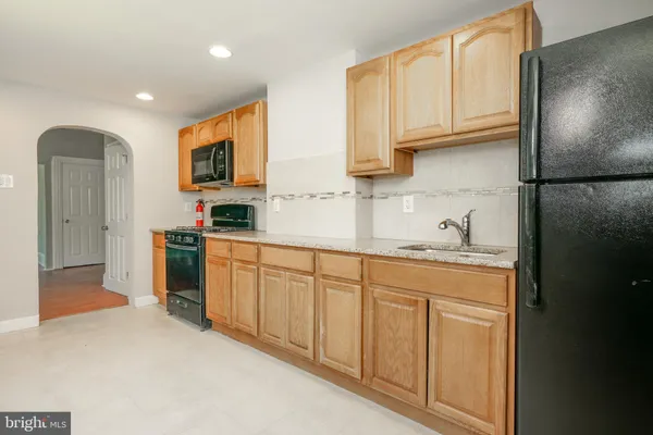 a kitchen with cabinets and a refrigerator