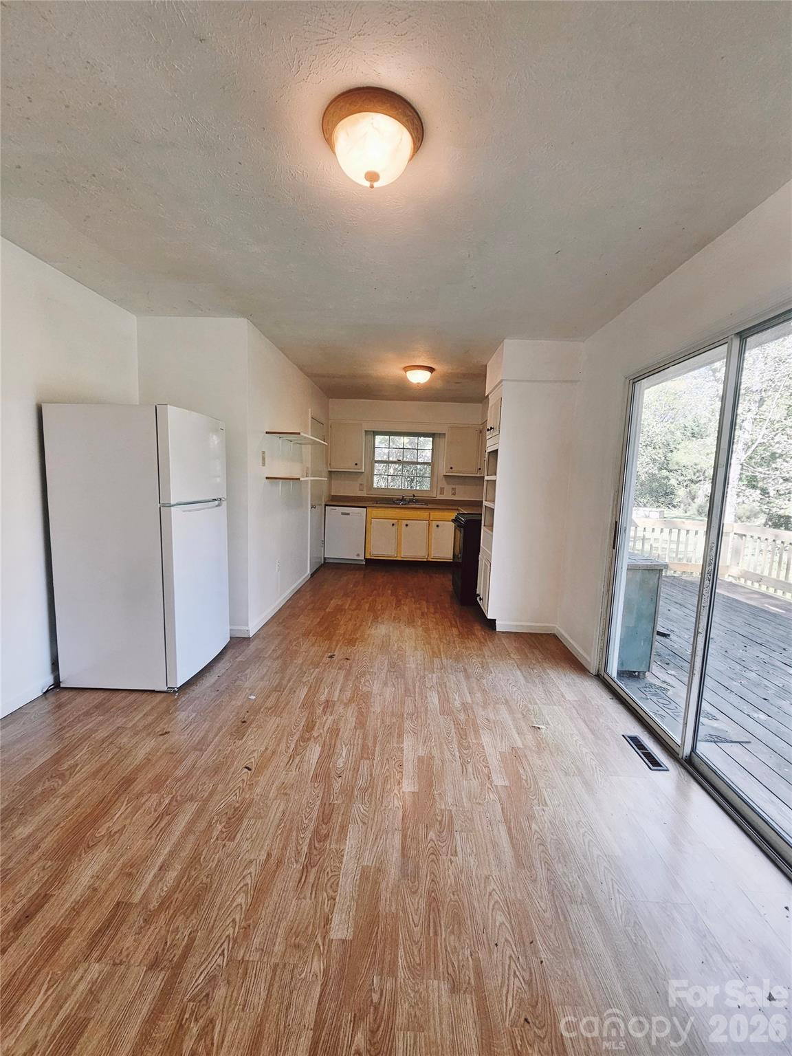 468 Beaverdam Road Asheville, NC 28804 - Photo 13 of 19 an empty room with wooden floor and windows