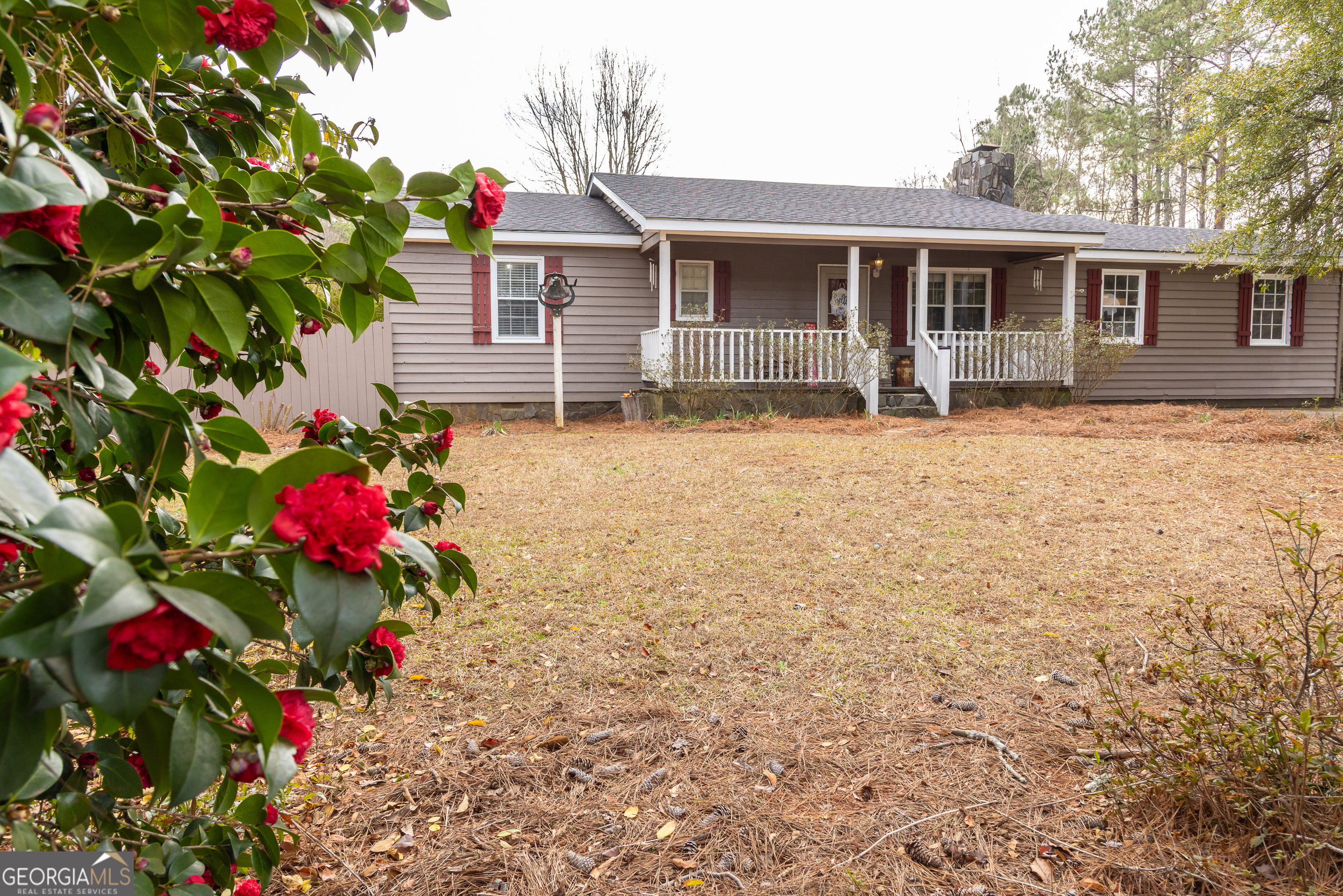 202 Daniel Road Thomaston, GA 30286 - Photo 1 of 112 a front view of a house with a yard and a garden