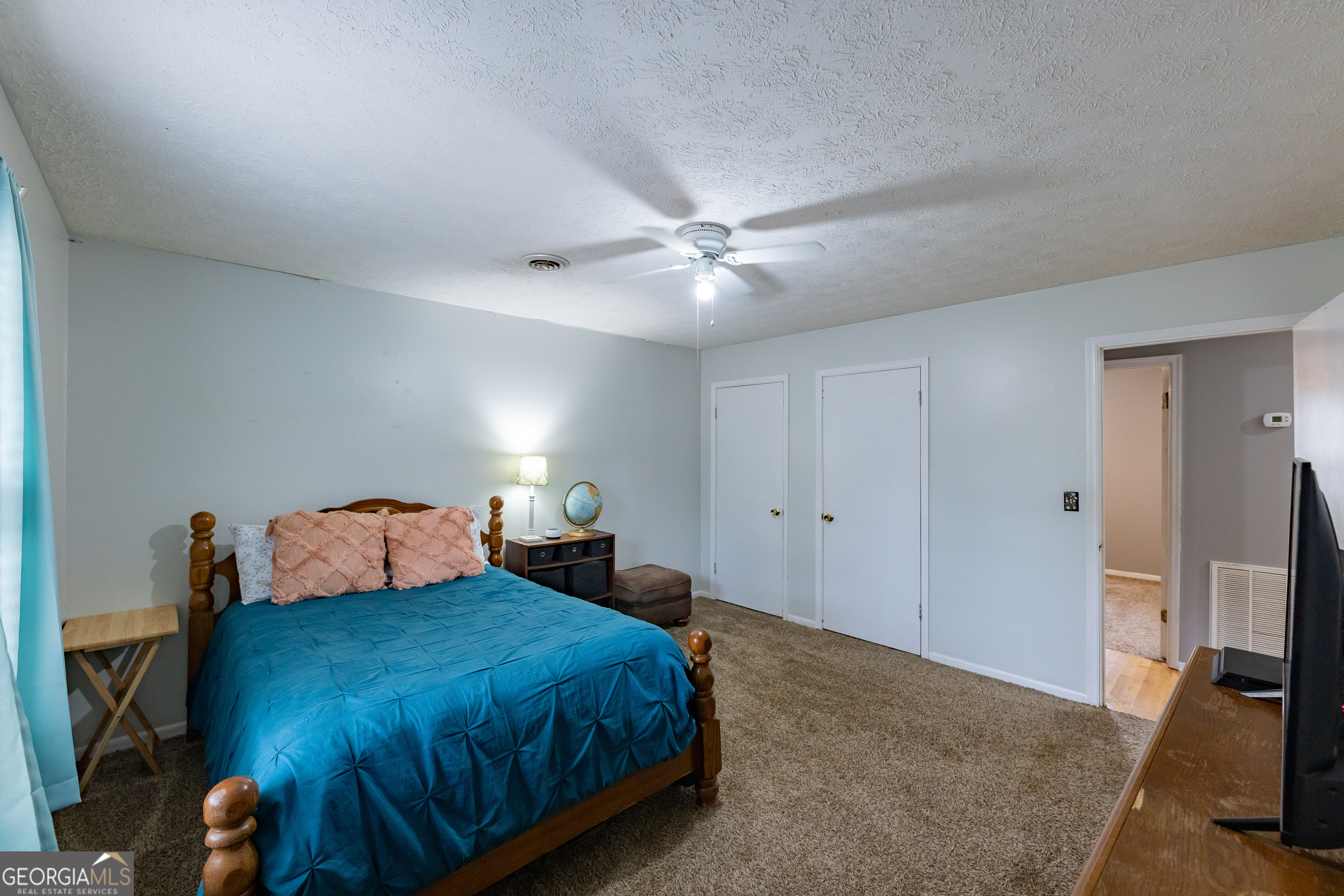 202 Daniel Road Thomaston, GA 30286 - Photo 16 of 112 a bedroom with a bed and a chandelier