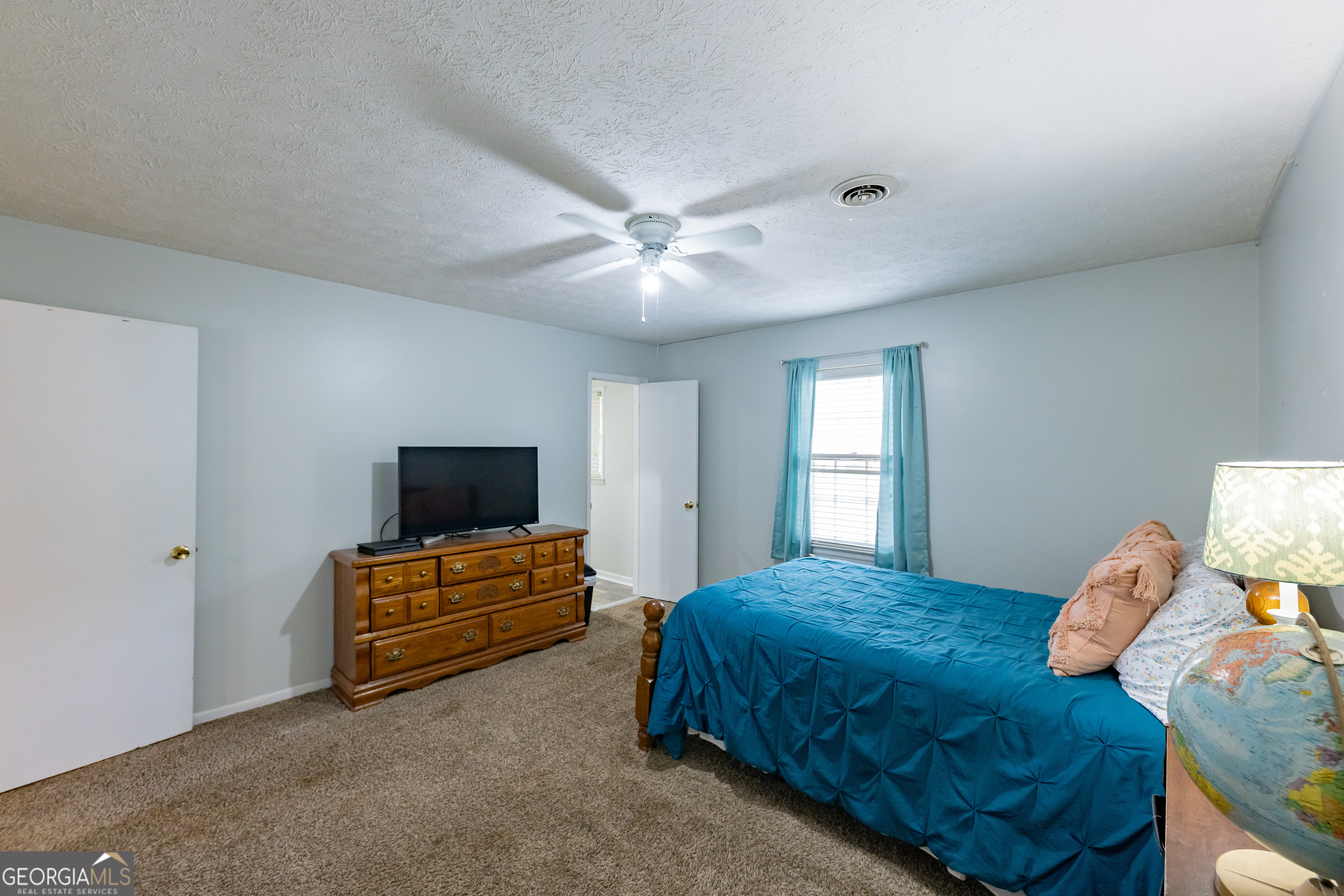 202 Daniel Road Thomaston, GA 30286 - Photo 17 of 112 a bedroom with a bed and a flat screen tv