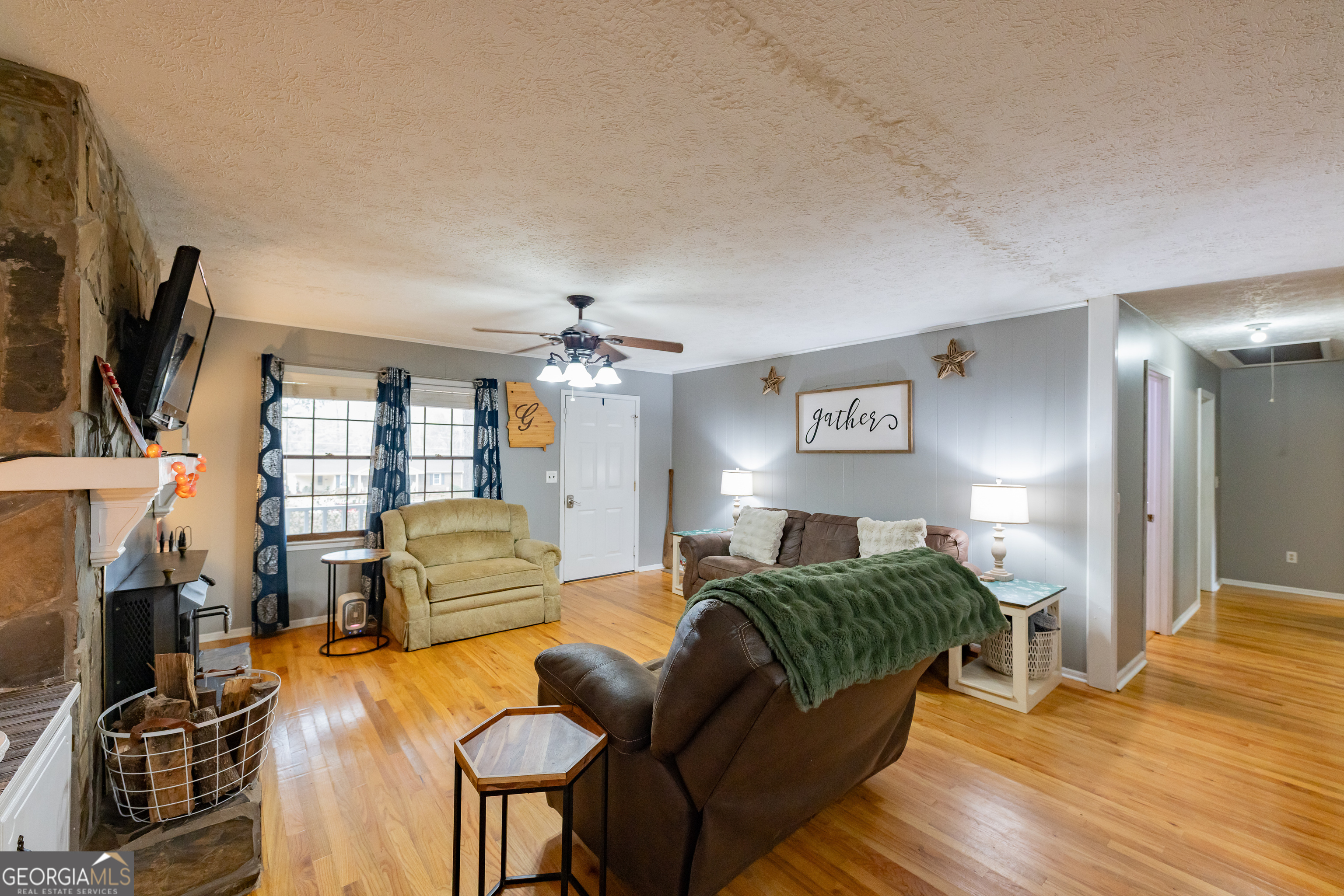 202 Daniel Road Thomaston, GA 30286 - Photo 3 of 112 a living room with furniture a flat screen tv and a fireplace