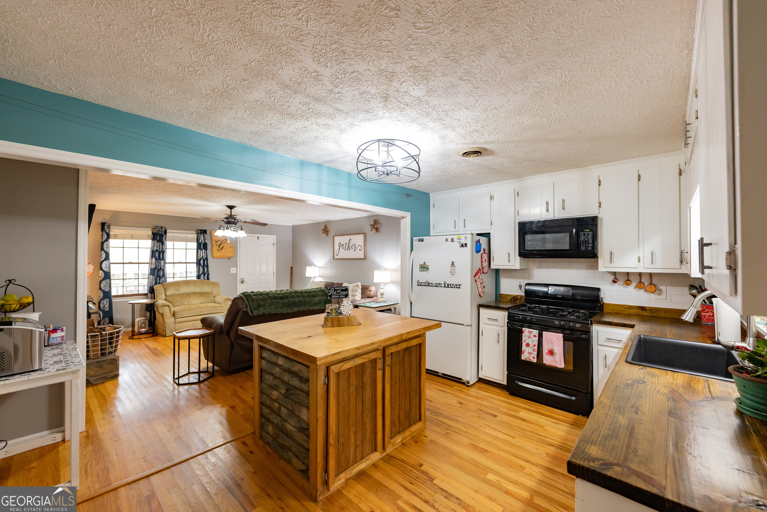 202 Daniel Road Thomaston, GA 30286 - Photo 7 of 112 a large kitchen with stainless steel appliances granite countertop a lot of counter space and wooden floor