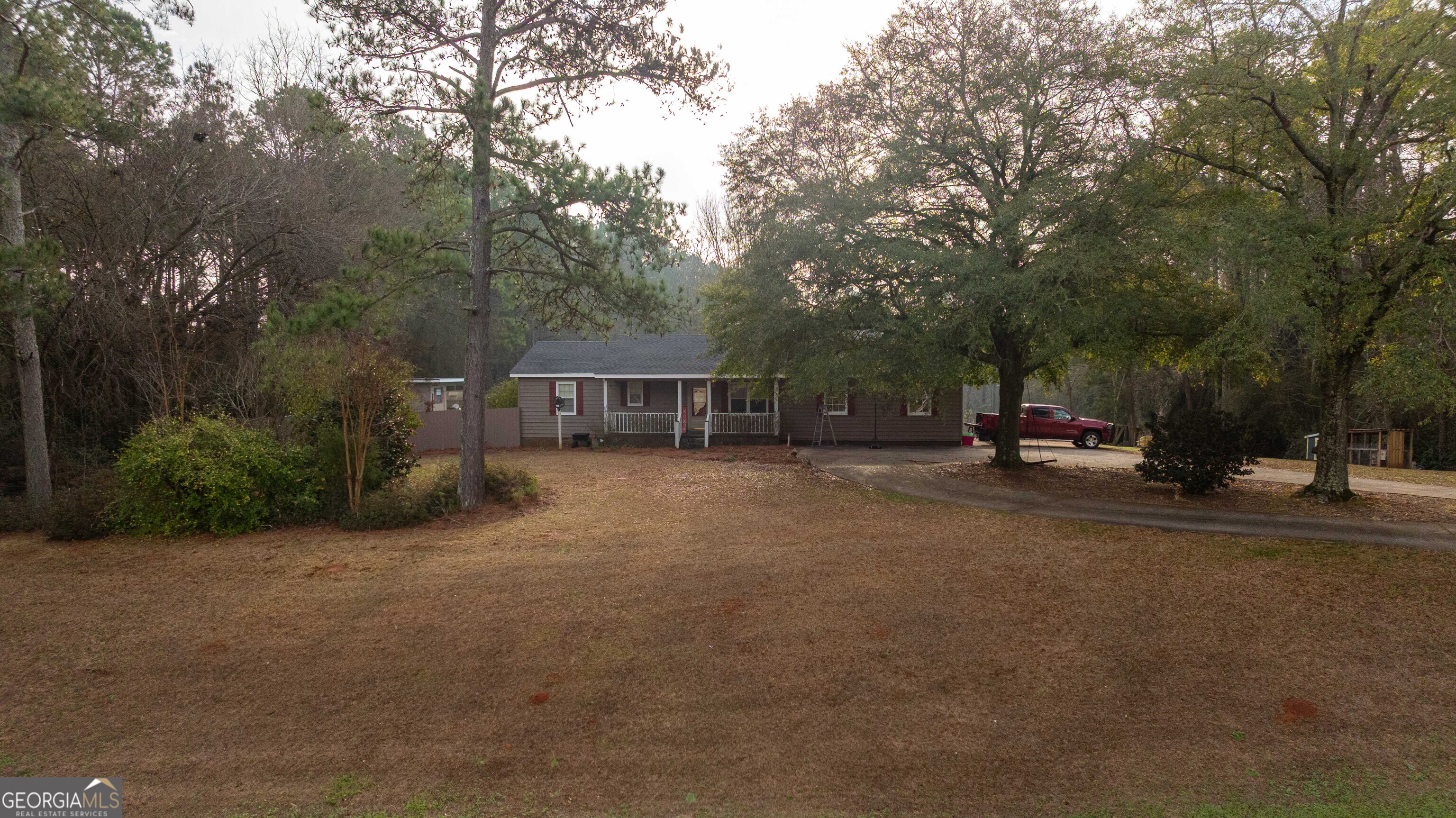 202 Daniel Road Thomaston, GA 30286 - Photo 91 of 112 a view of a street with a bench and trees