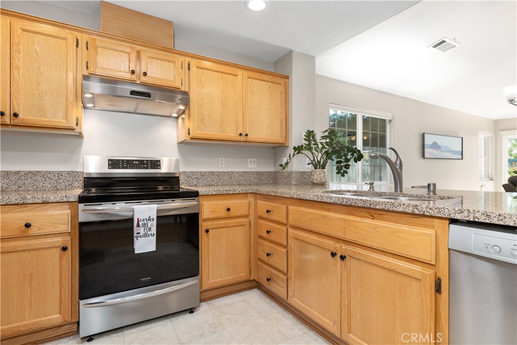408 Turtle Creek Road Paso Robles, CA 93446 - Photo 6 of 35 a kitchen with granite countertop white cabinets and white stainless steel appliances