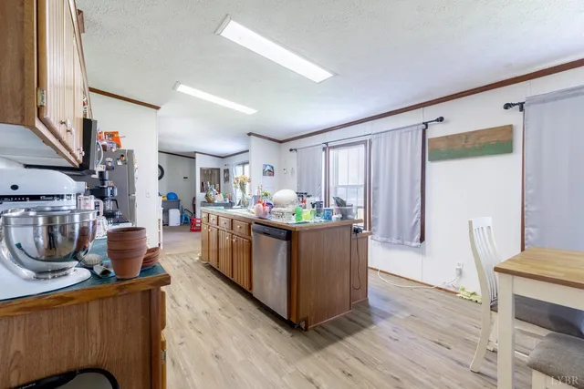 a room with wooden cabinets and stainless steel appliances