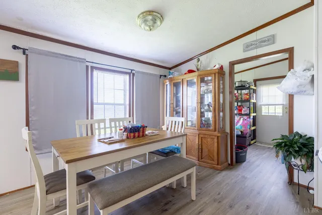 a dining room with furniture and wooden floor