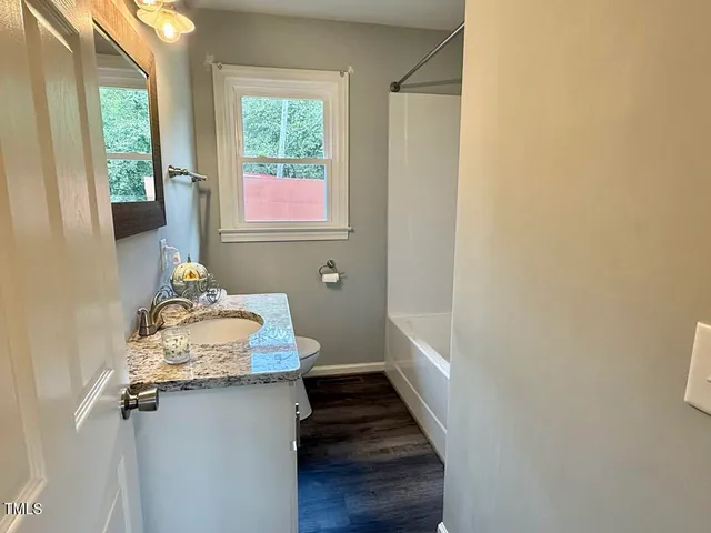 a bathroom with a sink toilet and tub