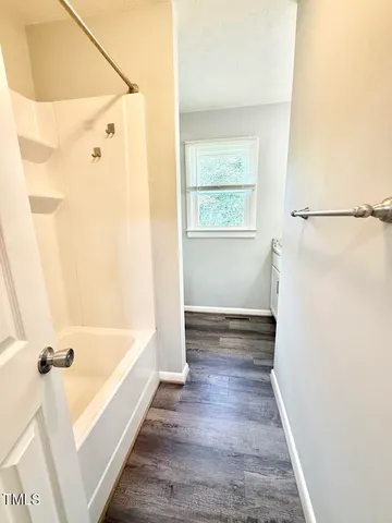 a view of a bathroom with a tub and shower