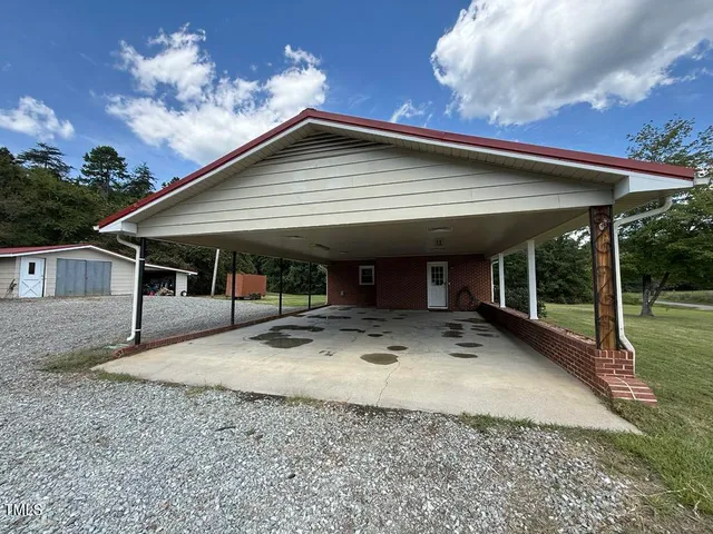 a view of a house with backyard porch and sitting area