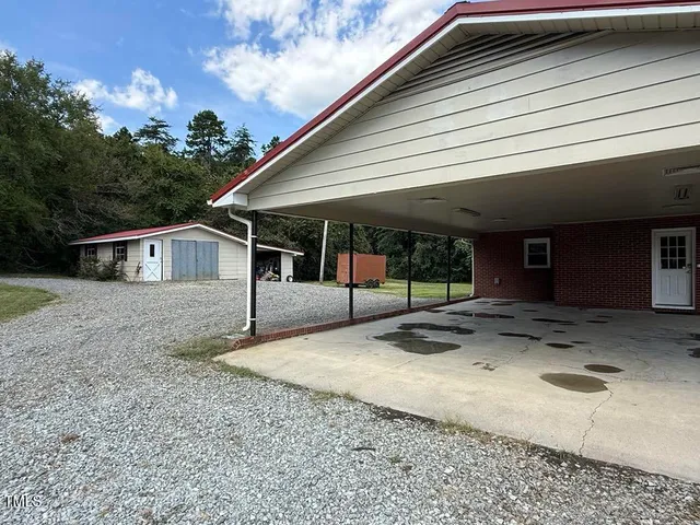 a view of a house with a yard and garage